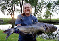 Woman holding a large catfish