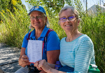 Joanne Langabee and Holly Hofreiter showing the notebook they use to record butterflies