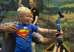 Boy practicing archery at Nebraska Game and Parks' state fair exhibit