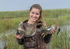 Woman holding up harvested ducks