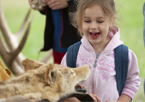 Girl smiling at wildlife furs on display