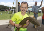 Girl holding a fish at Missouri River Expo