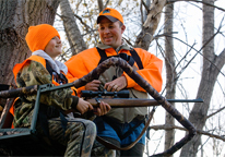 Father and son in a tree stand hunting deer