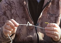 Closeup of someone tying a uni knot