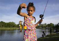 Girl holding up a channel catfish she caught