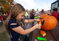 Girl carving a pumpkin