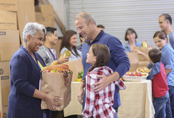 People accepting a bag of food at a food pantry