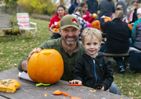 Father and son with pumpkin they're carving