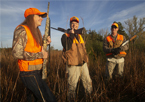 Pheasant hunters talking and smiling in the field