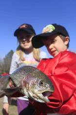 Kid holding a rainbow trout