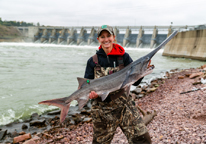 Female angler holding a paddlefish