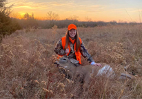 Hunter posing with harvested deer