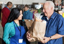 Man getting bags of food at a food pantry