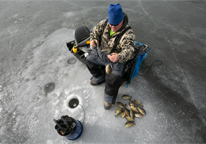 Overhead view of a man ice fishing