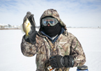 Ice angler holding up fish