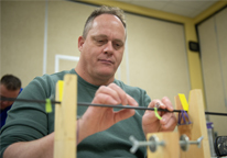 Man building a fly rod at a workshop