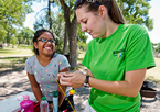 Outdoor educator working with child