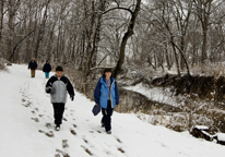 People hiking at Platte River State Park on a snowy winter day.