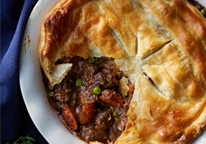 Venison pot pie with piece cut out of it