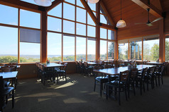 View of seating at Mahoney restaurant with large windows