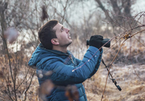 Man holding binoculars while bird watching