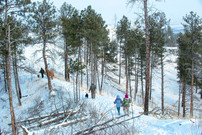 People hiking at Chadron State Park in winter.