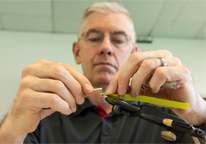 Man tying flies at a workshop