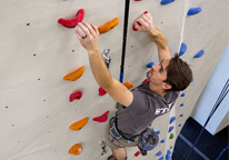 Man scaling the climbing wall at Mahoney State Park