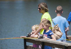 People fishing from a dock at the Fort Kearny Expo