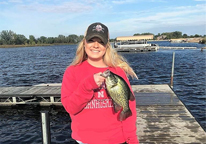 Woman holding up a crappie she caught