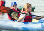 Kids paddling in a canoe at the Fort Kearny Expo