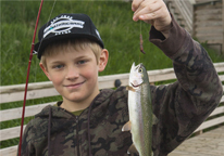 Boy holding up a rainbow trout