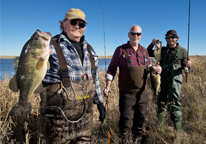 Anglers holding up fish