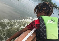 Boy in a boat wearing a life jacket