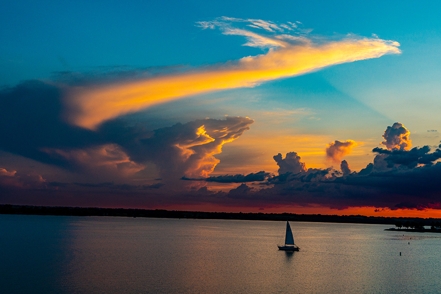 Sailboat on Branched Oak Lake under beautiful sunset