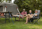 Family sitting outside their tent