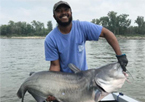 Angler holding a record blue catfish