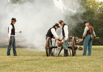 Reenactors shooting a canon at Fort Kearny State Historical Park