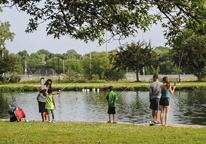 People fishing from the shore at a Community Fishing Event