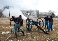 Reenactors firing a cannon at Fort Hartsuff