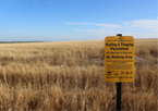 Land with Open Fields and Waters sign