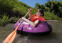 Girl tubing on river