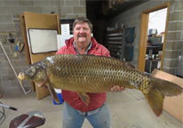 Man holding state record common carp