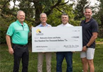 Game and Parks director Tim McCoy holding check