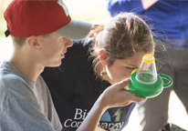 Kids looking at a find during a bioblitz