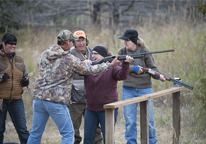 Woman being taught how to shoot