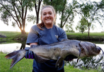 Female angler holding large catfish