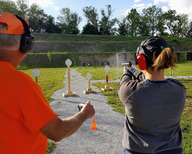 Woman firing a gun on the range at Platte River State Park