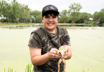 Boy holding a bullfrog