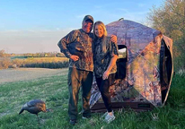 Greg Wagner and his daughter posing outside turkey blind